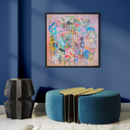 Abstract painting on a blue wall above a blue ottoman with a geometric design.