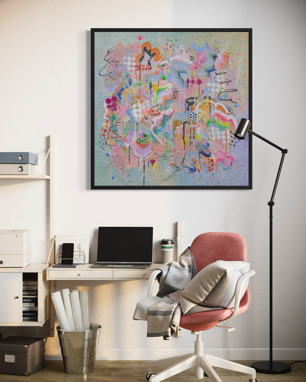 Modern office setup with a colourful abstract painting on the wall.