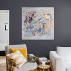 Modern living room with a colorful abstract painting on the wall, a gray armchair, and a white sofa.