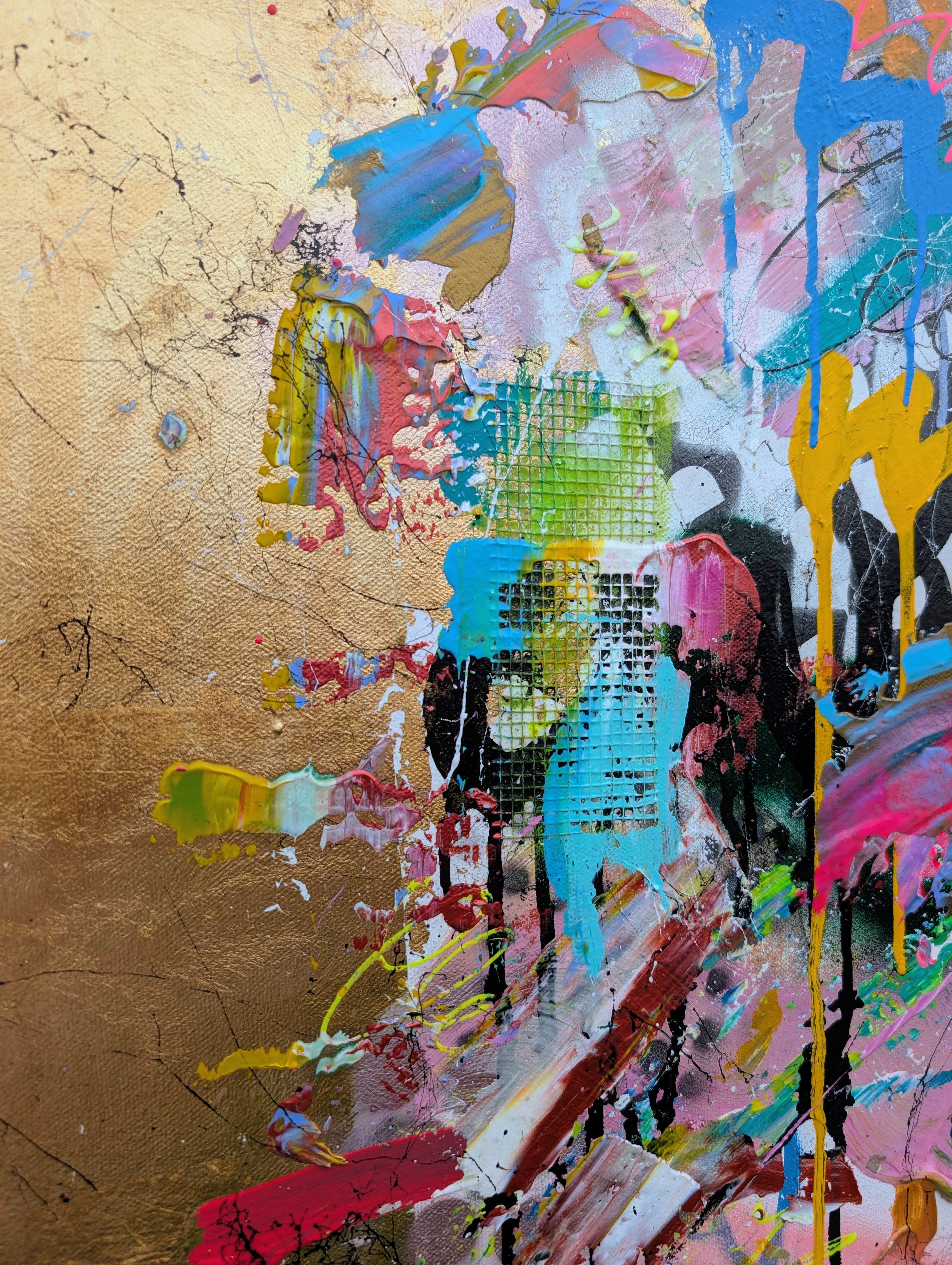 Abstract art piece with colorful splashes on a textured gold background