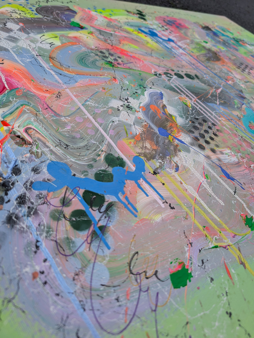 Abstract art with colorful splashes and a blue abstract shape on a textured surface.