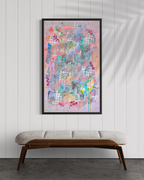 Colorful abstract painting on a white wall above a wooden bench.