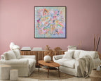 Living room with white sofa, coffee table, and colourful abstract painting on pink wall.