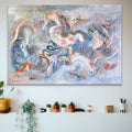 Abstract painting on a wall with a shelf below containing plants and decorative items.