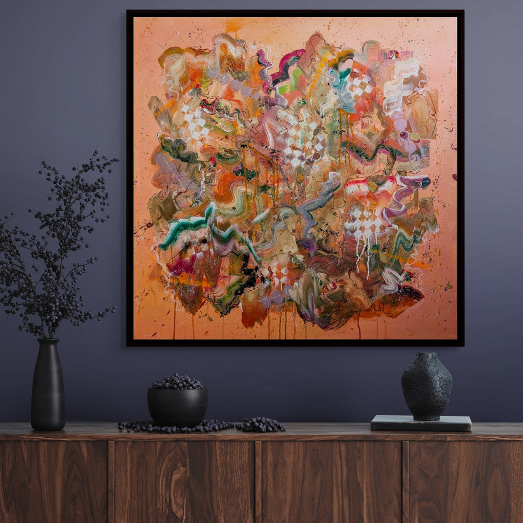 Abstract painting on a wall above a wooden cabinet with decorative items.