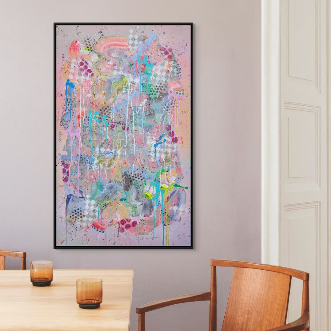 Abstract painting on a wall above a table with chairs