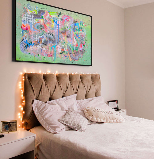 Bedroom with a bed, headboard, and colorful abstract painting on the wall.